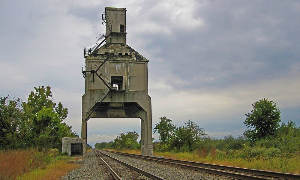 This structure, located near Grandview Estates north of town, is called a coal tipple, and many years ago its purpose was to supply steam locomotives with both coal for their fireboxes and water for the boilers. According to Harry Titus, the structure was saved from demolition when an American Eagle nest was discovered in it. In any case, the coal tipple was once a popular hang out where local teenagers would to drink and flirt and generally behave recklessly while trains raced below them.